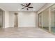 Living room with sliding glass doors and tile floors at 43958 W Stonecreek Rd, Maricopa, AZ 85139