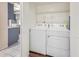 Laundry room with washer, dryer, and overhead shelving at 1222 W Baseline Rd # 121, Tempe, AZ 85283