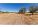 Dry, flat land with sparse desert vegetation at 11841 N Lavern Ln, Maricopa, AZ 85139