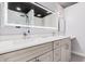 Modern bathroom with double vanity, large mirror, and walk-in shower at 8301 E Crestwood Way, Scottsdale, AZ 85250