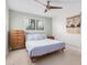 Bedroom with queen bed, dresser, and ceiling fan at 8301 E Crestwood Way, Scottsdale, AZ 85250