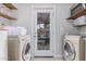 Bright laundry room with washer, dryer, and exterior access at 8301 E Crestwood Way, Scottsdale, AZ 85250