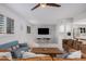 Bright living room featuring comfortable seating and a large TV at 8301 E Crestwood Way, Scottsdale, AZ 85250