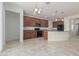 Modern kitchen with dark wood cabinets, granite countertops, and breakfast bar at 20403 W Calle Encorvada --, Buckeye, AZ 85396