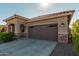 Home's exterior showcases a two-car garage and attractive landscaping at 20403 W Calle Encorvada --, Buckeye, AZ 85396