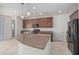 Open concept kitchen with an island and stainless steel appliances at 20403 W Calle Encorvada --, Buckeye, AZ 85396