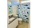 Bathroom with granite countertop, white cabinets, and shark-themed shower curtain at 18195 N San Juan St, Maricopa, AZ 85138
