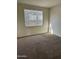 Bright bedroom with neutral carpeting and large window at 18195 N San Juan St, Maricopa, AZ 85138