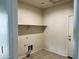 Laundry room with built-in shelving and tile floor at 18195 N San Juan St, Maricopa, AZ 85138