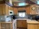 Bright kitchen with wood cabinets and ample counter space at 1432 S Havasupai Dr, Apache Junction, AZ 85119