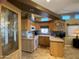 Open kitchen with wood cabinetry and breakfast bar at 1432 S Havasupai Dr, Apache Junction, AZ 85119