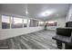 Bright sunroom with multiple windows and vinyl flooring at 10261 W Oak Ridge Dr, Sun City, AZ 85351