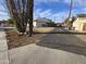 Side view of a single story home, showing the side yard and alley access at 11126 W Hollywood Ave, Youngtown, AZ 85363