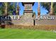 Gated community entrance with stone pillars and landscaping at 7740 E Gainey Ranch Rd # 24, Scottsdale, AZ 85258