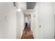 Long hallway with light wood laminate flooring at 11451 S Pawnee Cir, Phoenix, AZ 85044