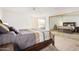 Bedroom with a wooden bed frame and mirrored closet doors at 11451 S Pawnee Cir, Phoenix, AZ 85044