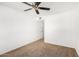 Spacious bedroom featuring a ceiling fan and door at 11451 S Pawnee Cir, Phoenix, AZ 85044