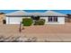 House exterior with a two-car garage and landscaping at 11451 S Pawnee Cir, Phoenix, AZ 85044