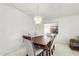 A dining room with a dark wood table and six light gray chairs at 11451 S Pawnee Cir, Phoenix, AZ 85044