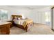 Spacious bedroom with a wooden bed frame and carpet flooring at 11451 S Pawnee Cir, Phoenix, AZ 85044