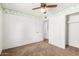 Bedroom with ceiling fan and closet at 11451 S Pawnee Cir, Phoenix, AZ 85044