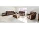 Spacious living room featuring a brown leather sectional sofa at 11451 S Pawnee Cir, Phoenix, AZ 85044