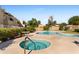 Relaxing community pool and spa with surrounding landscaping at 1425 E Desert Cove Ave # 49, Phoenix, AZ 85020