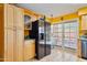 Kitchen features wood cabinets, stainless steel appliances, and backyard access at 1425 E Desert Cove Ave # 49, Phoenix, AZ 85020