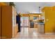 Bright kitchen with wood cabinets, stainless steel appliances, and access to a patio at 1425 E Desert Cove Ave # 49, Phoenix, AZ 85020