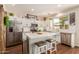 Modern kitchen with white shaker cabinets, quartz countertops, and stainless steel appliances at 2629 W Quick Draw Way, San Tan Valley, AZ 85144