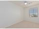 Simple bedroom with a window and ceiling fan at 28614 N Sunset Dr, San Tan Valley, AZ 85143