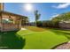 Relaxing backyard with covered patio and putting green at 28614 N Sunset Dr, San Tan Valley, AZ 85143