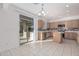 Kitchen with island, wood cabinets, and backyard access at 28614 N Sunset Dr, San Tan Valley, AZ 85143