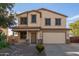 Two-story house with a beige exterior, two-car garage, and landscaping at 28614 N Sunset Dr, San Tan Valley, AZ 85143