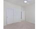 Bright bedroom featuring double doors to closet and adjacent room at 28614 N Sunset Dr, San Tan Valley, AZ 85143