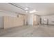 Spacious garage with ample storage cabinets and a refrigerator at 28614 N Sunset Dr, San Tan Valley, AZ 85143