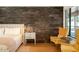 Main bedroom featuring wood-look floors and a feature wall at 2301 E Osborn Rd, Phoenix, AZ 85016