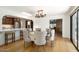 Bright dining room featuring a large table, chandelier, and hardwood floors at 2301 E Osborn Rd, Phoenix, AZ 85016