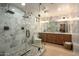 Elegant bathroom with marble shower, double vanity, and modern fixtures at 2301 E Osborn Rd, Phoenix, AZ 85016