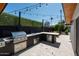 Modern outdoor kitchen with grill, sink, and ample counter space at 2301 E Osborn Rd, Phoenix, AZ 85016