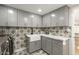Modern laundry room with gray cabinets and white farmhouse sink at 2301 E Osborn Rd, Phoenix, AZ 85016