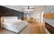 Spacious main bedroom with fireplace, wood-look floors, and ceiling fan at 2301 E Osborn Rd, Phoenix, AZ 85016