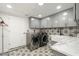 Modern laundry room with marble countertops and subway tile at 2301 E Osborn Rd, Phoenix, AZ 85016