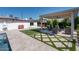 Spacious backyard with covered patio, putting green, and pool at 2301 E Osborn Rd, Phoenix, AZ 85016
