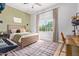 Bedroom with wooden bed frame, green accent wall, and built-in workspace at 3916 E Encanto St, Mesa, AZ 85205