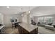 Open concept kitchen and living room with island and gray sofa at 9333 E University Dr # 45, Mesa, AZ 85207
