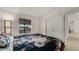 Primary bedroom with a floral comforter and access to the backyard at 9333 E University Dr # 45, Mesa, AZ 85207