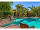 Large pool with a patio chair and lush tropical landscaping at 8100 N 68Th St, Paradise Valley, AZ 85253