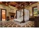 Spacious bedroom with a large canopy bed and a cozy fireplace at 8100 N 68Th St, Paradise Valley, AZ 85253
