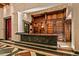 Custom wet bar with dark countertop and extensive wooden cabinetry at 8100 N 68Th St, Paradise Valley, AZ 85253
